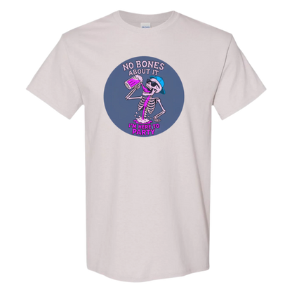 A ice grey t-shirt features a circular graphic with a dark blue background. Inside the circle, a pink skeleton wearing sunglasses and a blue baseball cap is enthusiastically drinking a bright pink, foamy beverage. Pink liquid is splashing around its lower body. Above the skeleton is the text "NO BONES ABOUT IT" in a semi-circular arrangement, and below is "I'M HERE TO PARTY" in a slightly curved, bold font.